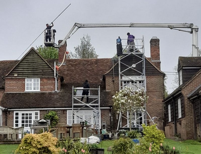 The Moss Cleaners using cherry picker and scaffolding to clean roof safely and professionally in Locks Heath, Hampshire